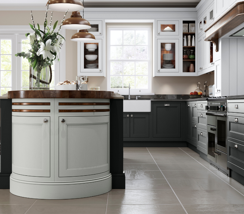 Sutton kitchen painted in Shell & Gun Metal Grey with barrel unit with Walnut inset chopping boards